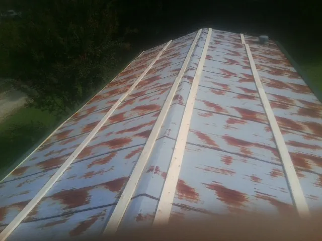 Rusted metal roof panels with new wood purlins before replacement — Storm Damage Roof Repair in Salters by Roofing Brothers